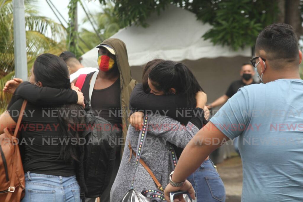 Venezuelans hug earch as some of them prepare to board a boat at Cedros to return to their homeland on in this January file photo.  Photo by Marvin Hamilton