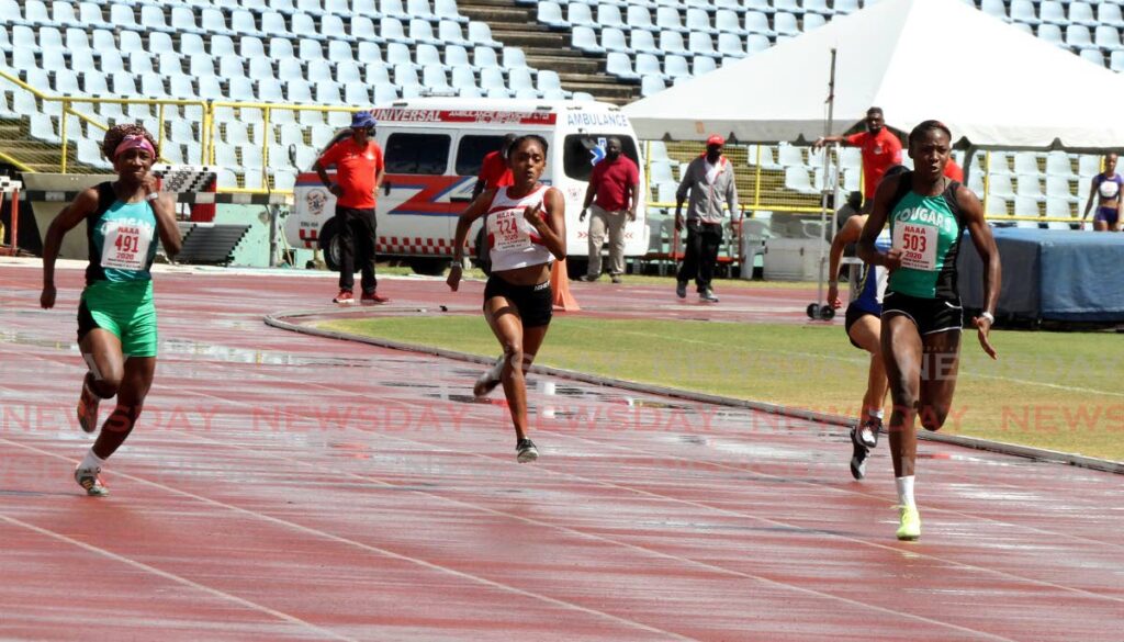 Cougars' Shaniqua Bascombe (R) races to the finish line in first place of the Girls U-20 100m, during day one of the NAAA's preparation meet, held at the Hasely Crawford Stadium, Port of Spain, on Saturday. - Angelo Marcelle