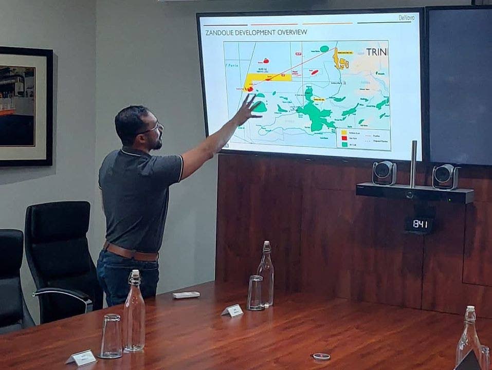 Energy Minister Stuart Young examines a digital map of De Novo's Zandolie exploration project during a visit to the company at the Pt Lisas Industrial Estate on Monday. Source: Stuart Young Facebook page. - 