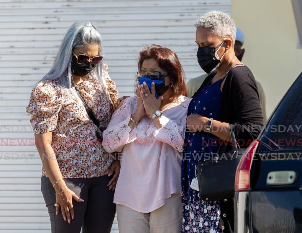 Relatives of deceased local actress Vanna Girod console each other outside the Scarborough mortuary, where an autopsy was done on Tuesday.  - David Reid