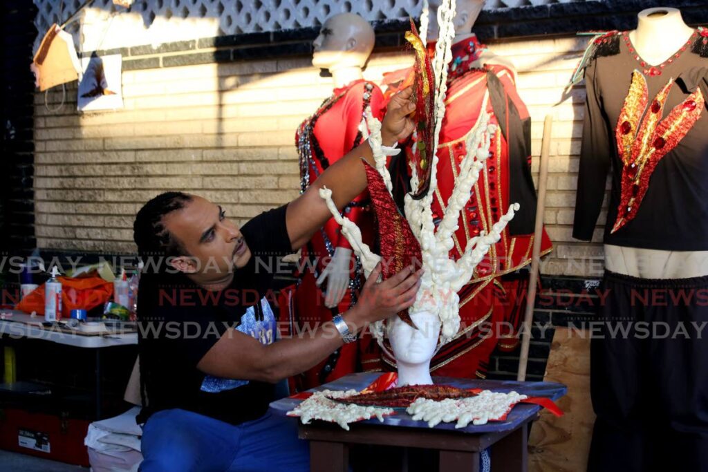 Masman Fareid Carvalho works on the headpiece of his 2022 presentation at his mas camp on Alfredo  Street in Woodbrook on February 3. Carvalho has competed for 21 years in the Carnival King competition at the Queen's Park Savannah, Port of Spain. - Photo by Sureash Cholai