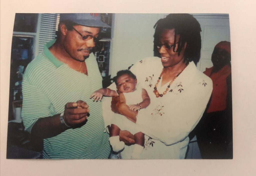 Elizabeth Montano holding Machel Jah-Marley Baptiste with Winston Montano. - 