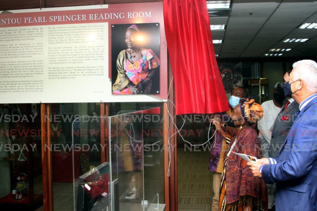 Port of Spain Mayor Joel Martinez stands alongside Eintou Pearl Springer at the unveiling of a reading room in her honour at the Heritage Library, Port of Spain. - Angelo Marcelle