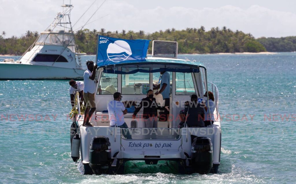 Stakeholders take a ride on board Top Catch Charters in Buccoo on Friday after a ceremony to honour the awarding of Blue Flag status at Merci Buccoo Hall, Buccoo. Photo by  David Reid