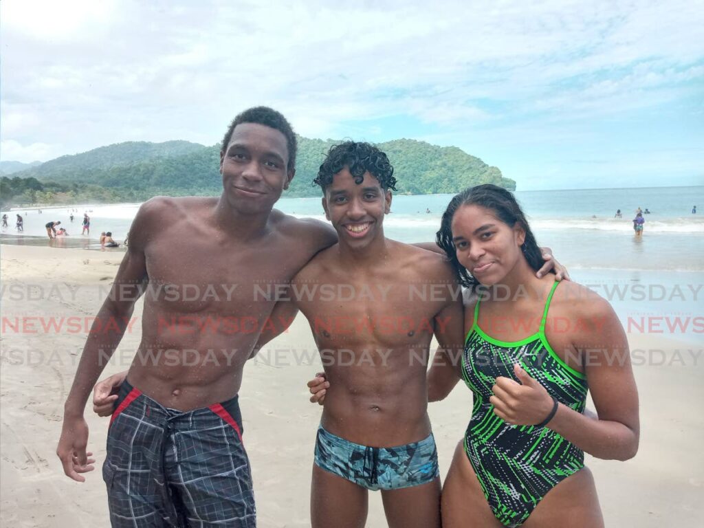 Nikoli Blackman, left, along with Zachary Anthony, middle, and Zoe Anthony at the ASATT CARIFTA Open Water trials at Las Cuevas Bay, on Sunday. Blackman finished first, followed by Zachary and Zoe.  - Jelani Beckles