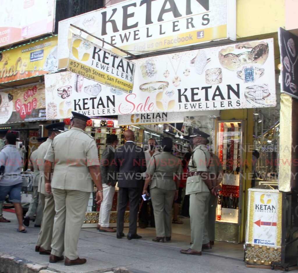 FILE PHOTO: Andy Alberto Macias-Hosein, centre (white shirt), speaks with San Fernado Mayor Junia Regrello (black suit) accompanied by a delegation of senior police officers at the Ketan Jewellers on High Street, during the launch of an anti-crime initiative for the city in December 3, 2021. Macias-Hosein was killed by bandits during a robbery at the store on February 8. - ROGER JACOB