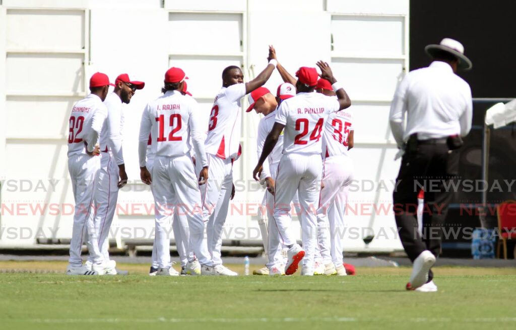 In this photo taken, on Wednesday, TT Red Force players celebrate the dismissal of Jamaican Scorpions' Leroy Lugg, during Day 1 of the CWI Regional Four-Day Championship match, at the Brian Lara Cricket Academy, Tarouba. Red Force won the match by three wickets, on the final day, on Saturday,  - Lincoln Holder