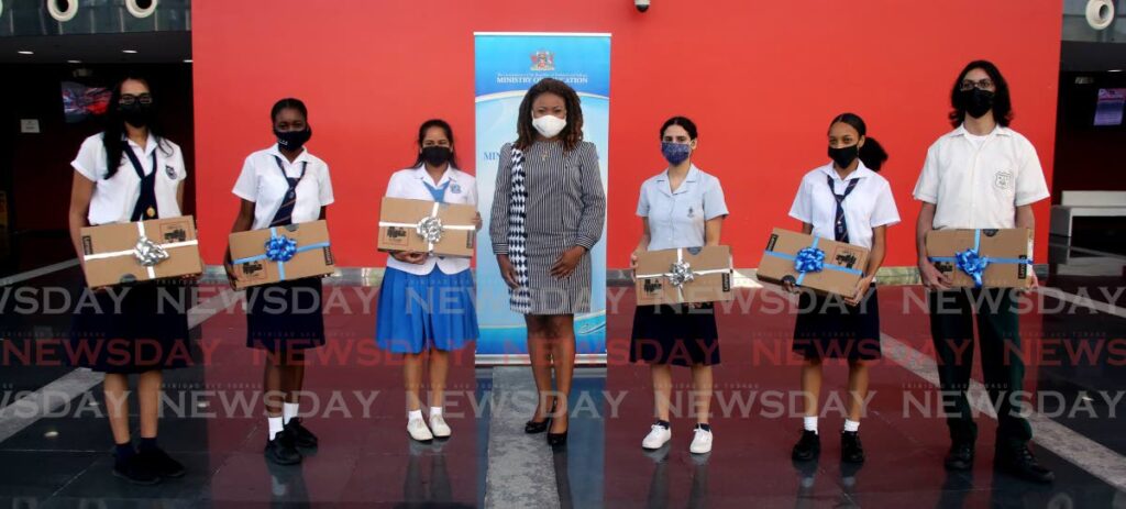 Education Minister Dr Nyan Gadsby-Dolly (middle) poses with the top TT CXC awardees. From left - Jesse Rampersad of Naparima Girls High School, Ayana Felix of Bishop Anstey High School East, Nikeesha Nancoo of Laksmi Girls, Zoe Gonzalves of St Joseph Convent Port of Spain, Tashana Riley of Bishop Anstey High School East, and Joshua Brailey of ASJA Boys Charlieville at NAPA, Port of Spain. - SUREASH CHOLAI