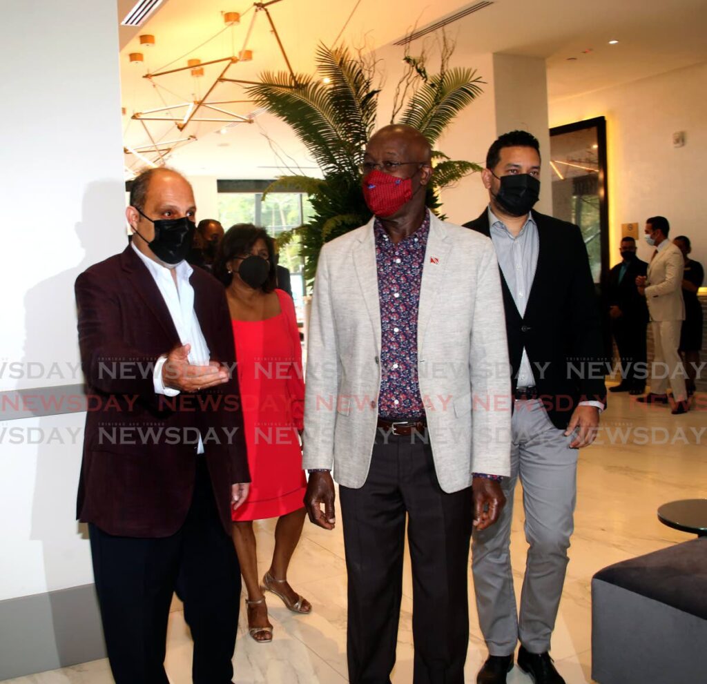 PM Dr Keith Rowley is welcomed by John Aboud chairman of Superior Hotels, left, at the opening The Brix Hotel in St Ann's on February 12. - SUREASH CHOLAI