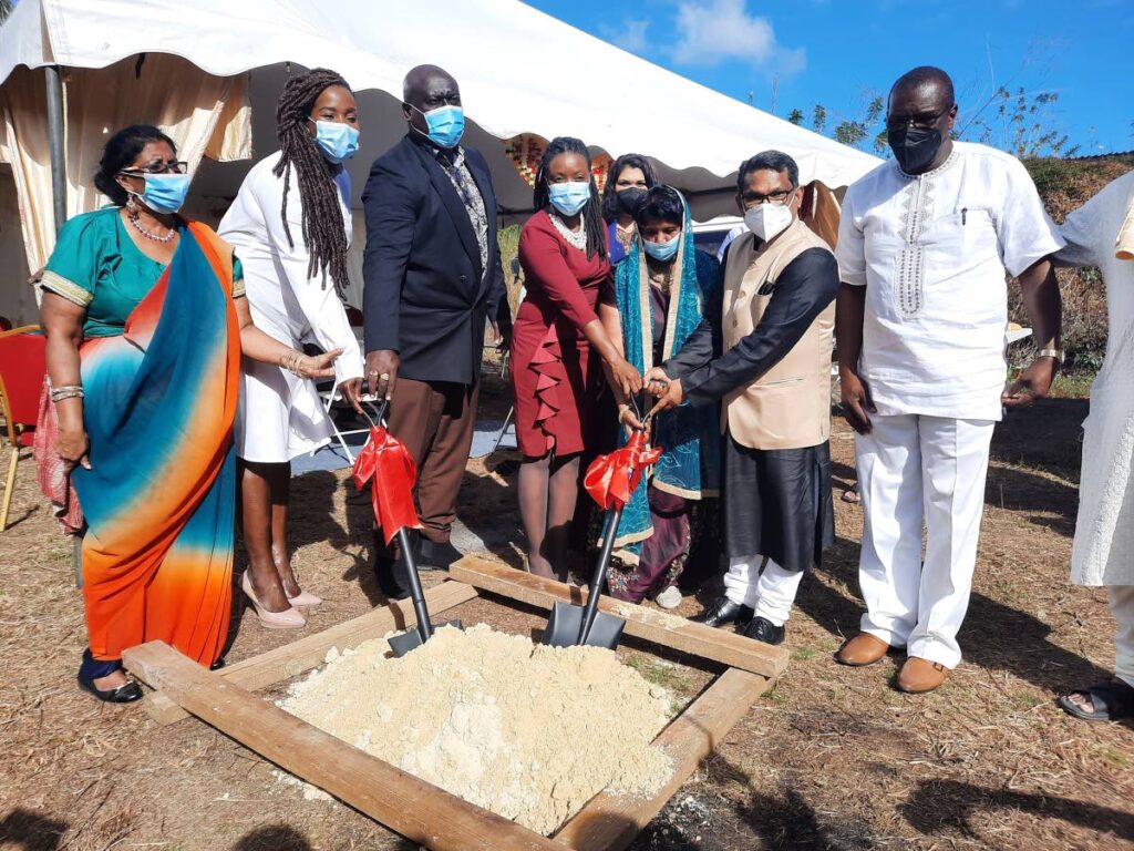 Indian High Commissioner Arun Kumar Sahu, second from right, turns the sod for the construction of Tobago's first Hindu temple, alongside Tobago Hindu Society president Pulwaty Beepath, third from right, and Secretary of Culture Tashia Burris, on Saturday in Signal Hill. PHOTO COURTESY TOBAGO UPDATES  - 