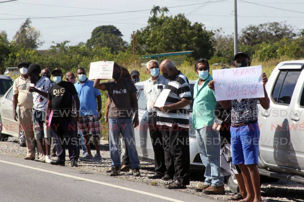 Some of the ex-Caroni workers who protested outside the Nutrimix hatchery at Brechin Castle, Couva. - Photo by Lincoln Holder