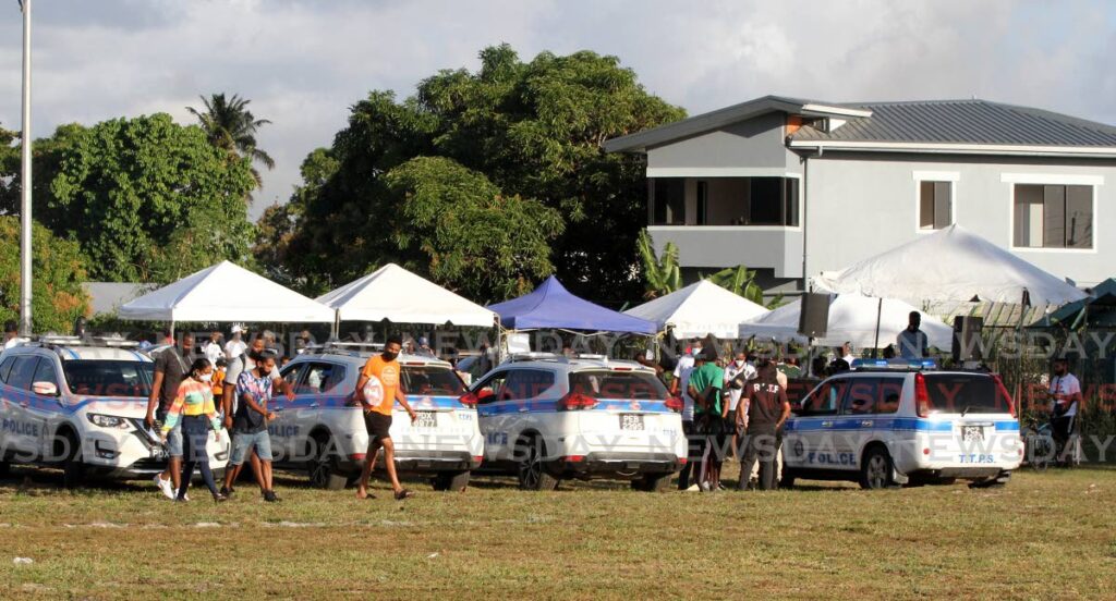 Police officers attached to the Road Policing Task Force check to ensure all public health protocols were being observed, during 'For The Love of Malabar' football competition on Sunday, at the India Grounds, Malabar. - Angelo Marcelle