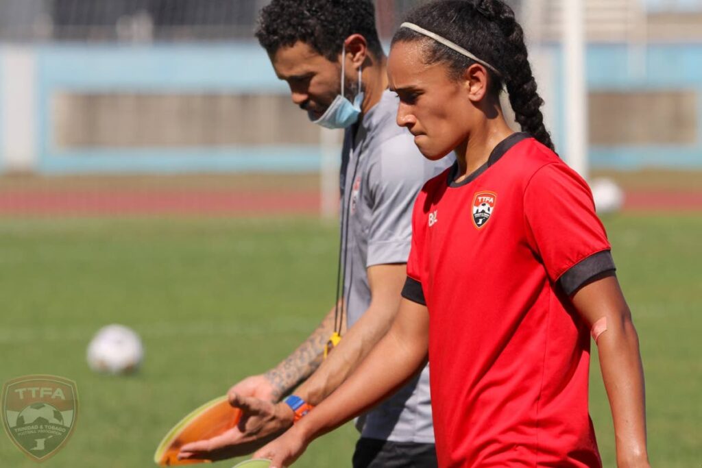 Trinidad and Tobago women’s football team newcomer Shani Nakhid-Schuster (R) walks alongside assistant coach and former player Carlos Edwards during a team training session ahead of the team’s Concacaf  World Cup qualifying match, against Nicaragua, on Thursday, at the Hasely Crawford Stadium, Port of Spain.  - TTFA Media
