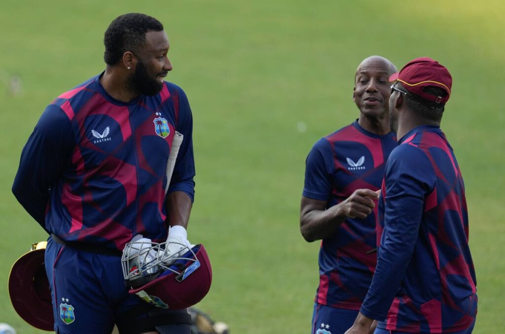 West Indies' captain Kieron Pollard, left, talks with teamates during a practice session ahead of the first Twenty20 international against India in Kolkata, India, on Tuesday. (AP Photo) - 