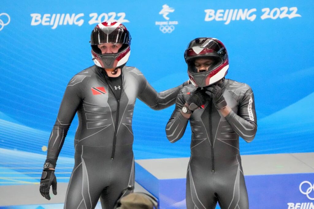 Axel Brown (L) and Shakeel John, of Trinidad and Tobago, stand at the finish area after the two-man heat 3 at the 2022 Winter Olympics, on Tuesday, in the Yanqing district of Beijing. (AP Photo) - 