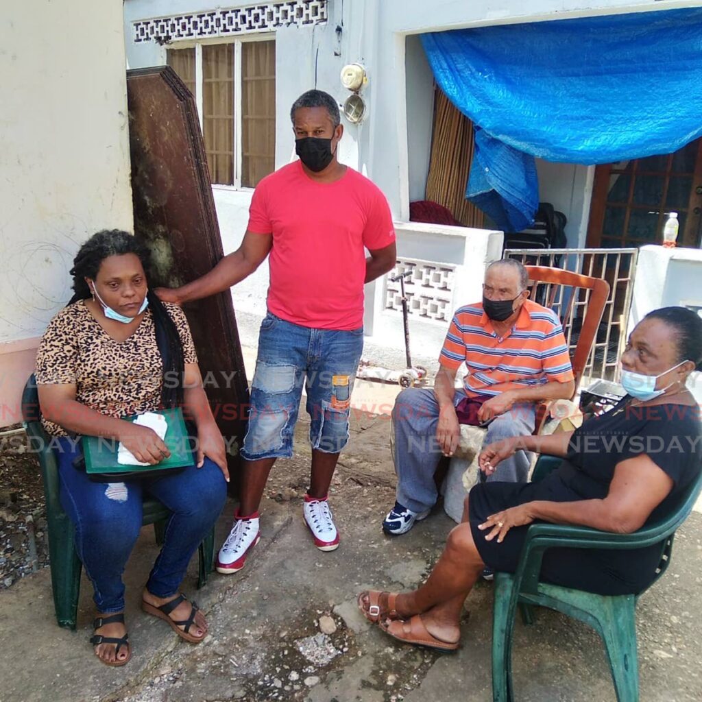 Mother of Antonio Badenoch, Philippa Ramsewak, left, stepfather Andrew Baptiste, father Wilfred Badenoch and grandmother Elaine Phillip-Ramsewak console each other at St Vincent Street, Tunapuna on Thursday. Antonio was gunned down during Wednesday's blackout. - PHOTO BY SHANE SUPERVILLE