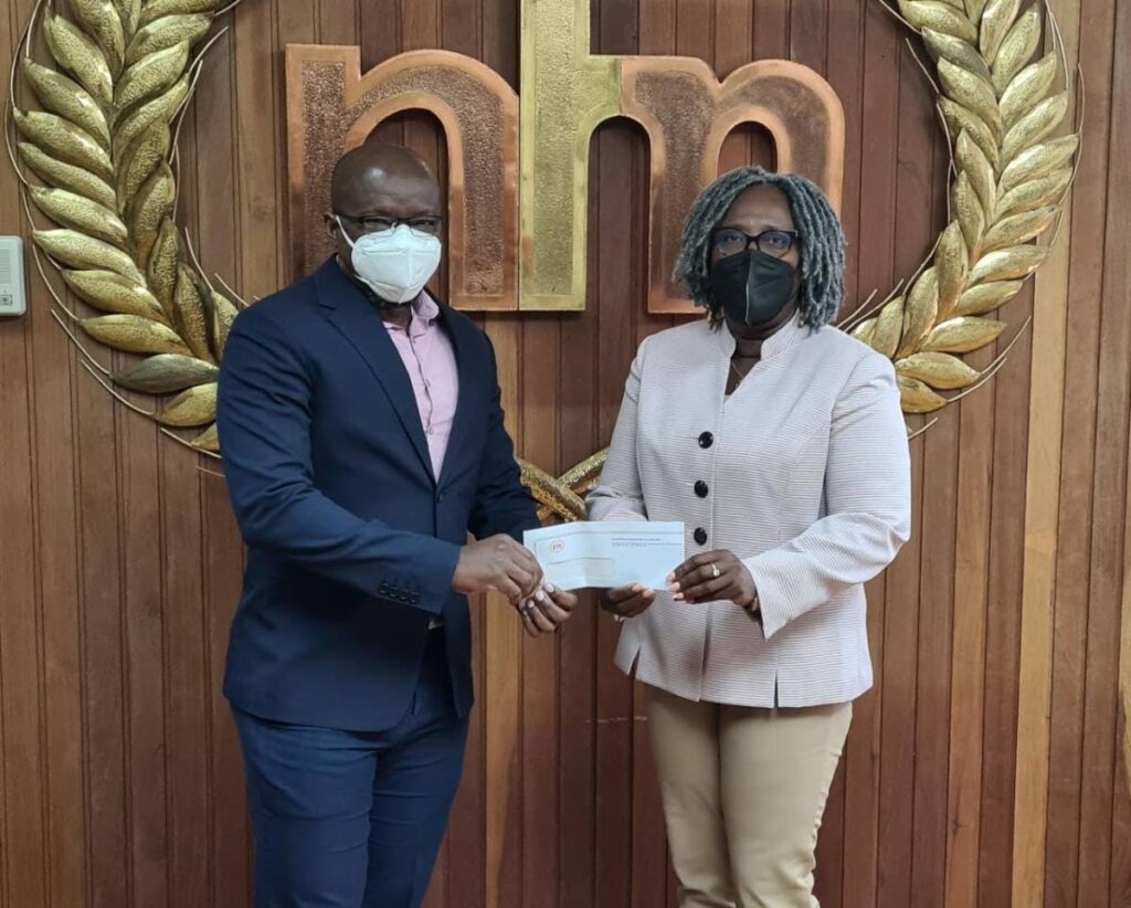 National Flour Mills CEO Ian Mitchell (left) presents a cheque to Pan Trinbago president Beverly Ramsey-Moore. Photo courtesy NFM