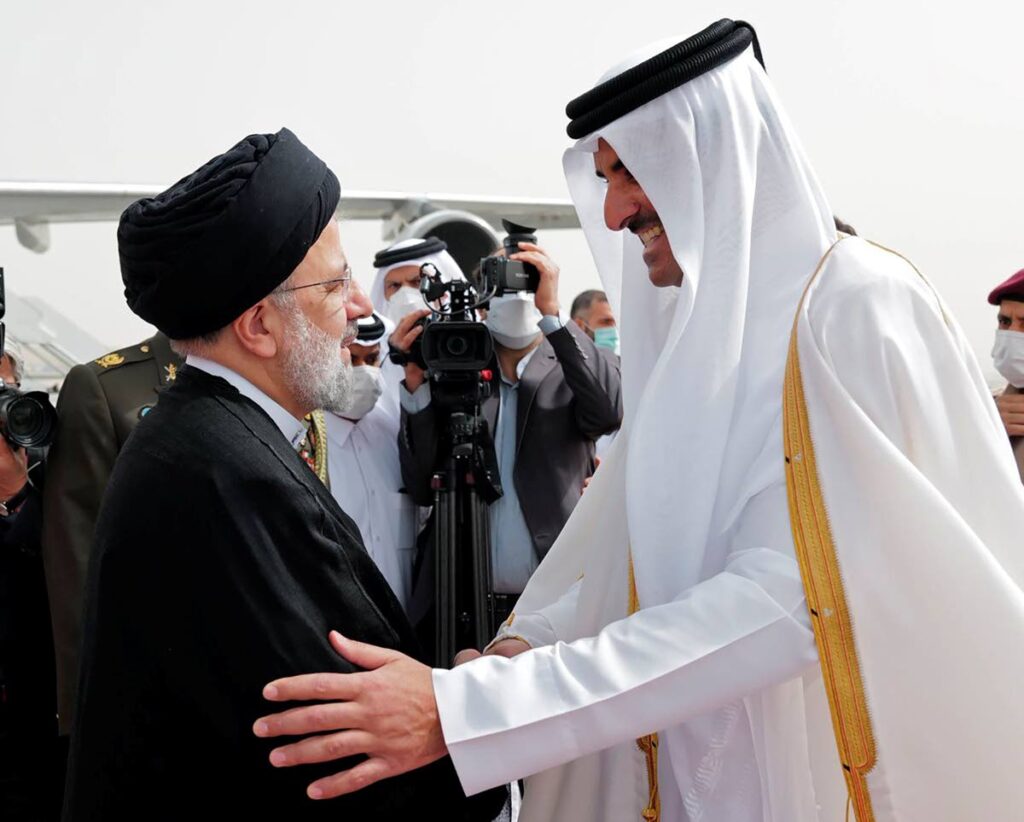 In this photo made available by Qatar News Agency, QNA, President of Iran Ebrahim Raisi, left, is welcomed by Qatari Emir Tamim bin Hamad Al Thani, as he arrives in Doha, Qatar, on Monday. - AP PHOTO