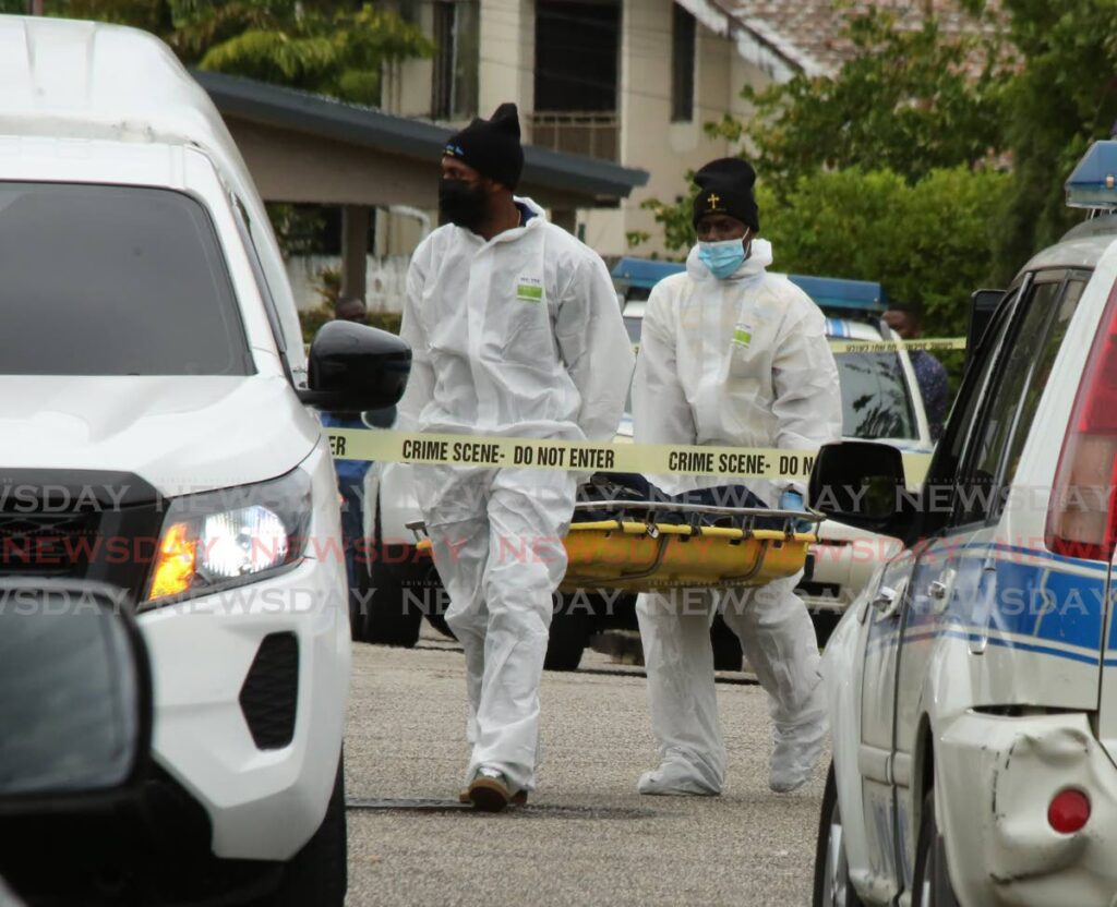 Undertakers remove a body from the scene of a shootout at Cherry Crescent, Westmoorings on Thursday. - SUREASH CHOLAI