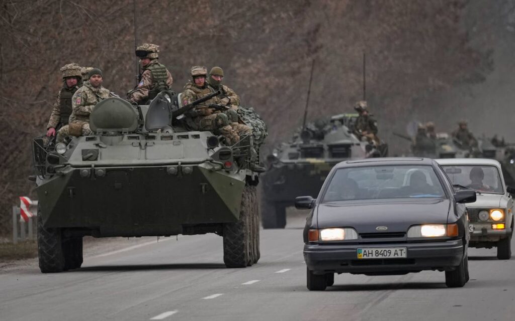 Ukrainian servicemen sit atop armored personnel carriers driving on a road in the Donetsk region, eastern Ukraine, Thursday. AP PHOTO - 
