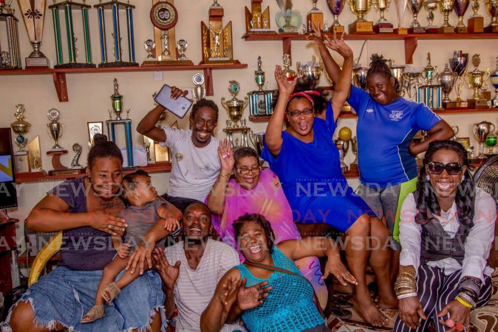 Stoute Next Generation members celebrate their 2019 Tobago Band of the Year crown with former matriarch Gloria Stoute, seated centre, who died in September last year. - 