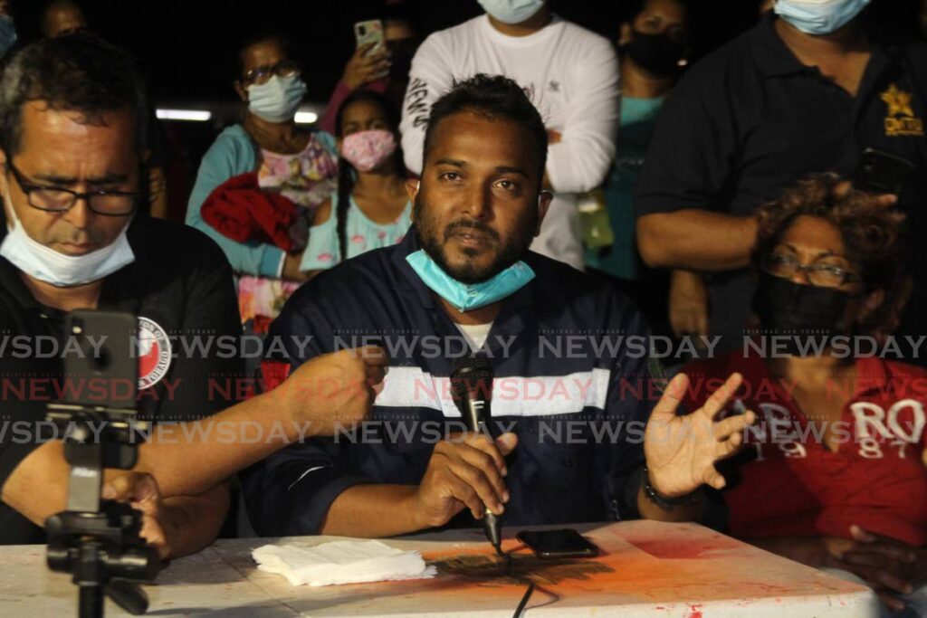 Michael Kurban, centre, son of missing diver Fyzal Kurban, criticises Paria Fuel Trading Company for its response to Friday's tragedy when five divers were sucked into an underwater 36-inch pipeline while performing routine maintenance work. - Marvin Hamilton