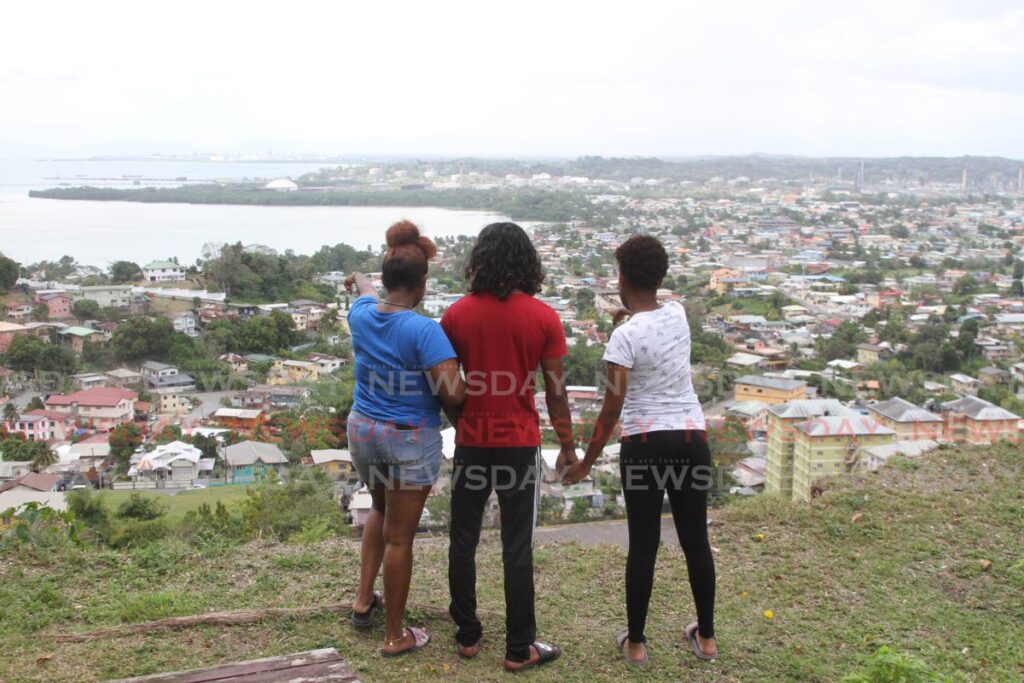 This group of friends who were the only ones visitors on San Fernando Hill, said they are happy for the re-opening. They visited on Carnival Monday to have a view of the city from above.  Photo by Marvin Hamilton