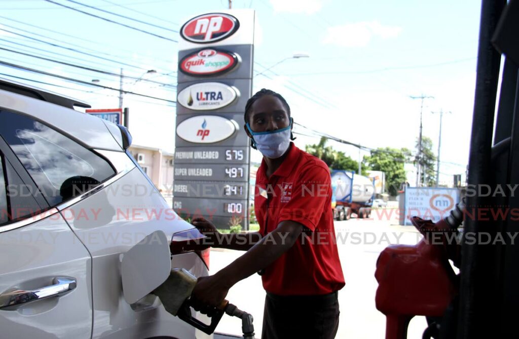 FILE PHOTO: A gas station pump attendant fill a car with premium unleaded gas at St Christopher's Service Station on Wrightson Road, Port of Spain. - 