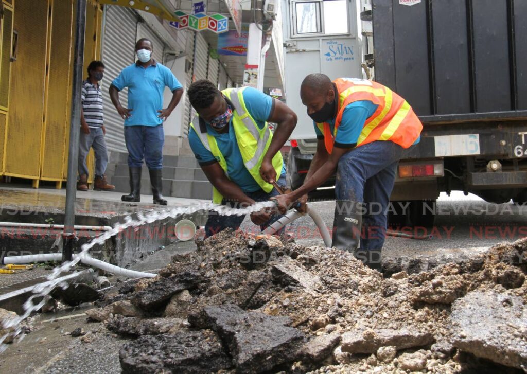 In this file photo, WASA workers repair a leaking line at High Street, San Fernando. - AYANNA KINSALE