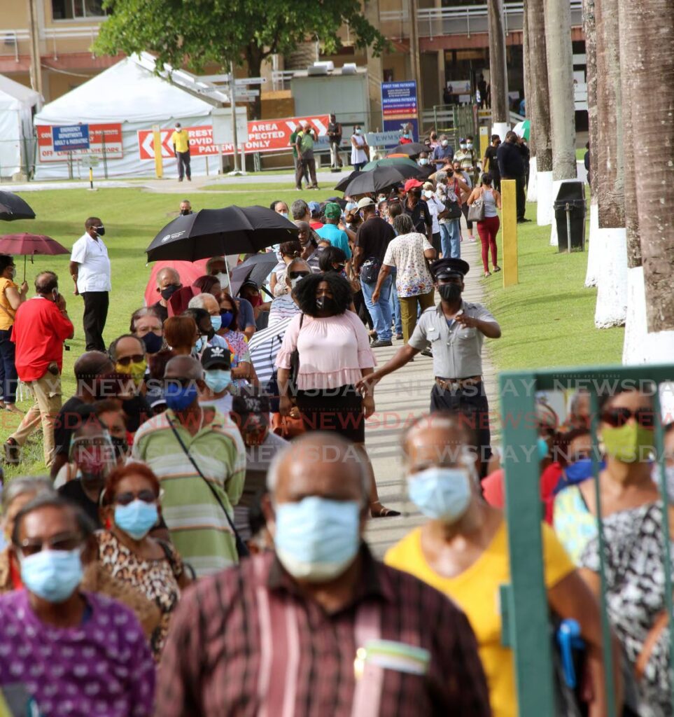 In this June 2021 file photo, a large crowd hoping to get their covid19 vaccine arrived early at the St. Joseph Enhanced Health Centre in Mt Hope. - Photo by Sureash Cholai