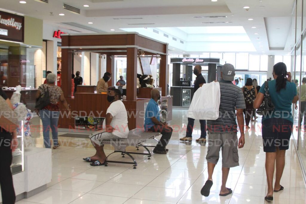 Shoppers in C3 Centre, San Fernando. The IMF said non-energy activity was picking up to boost economic activity. - PHOTO BY MARVIN HAMILTON
