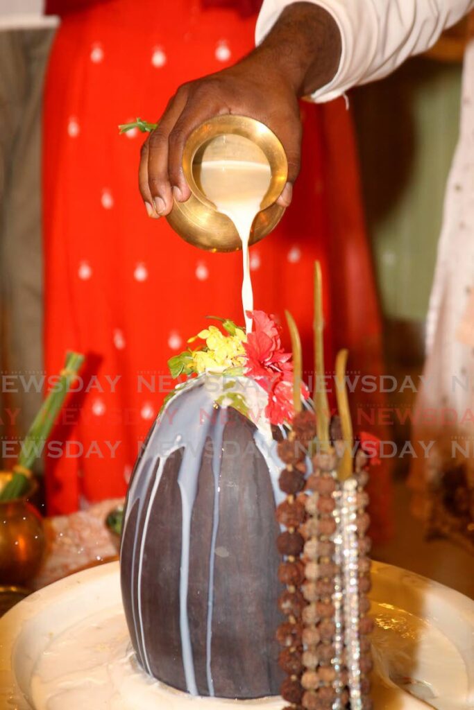 The Shiva lingam is showered with abhishek, a ritualistic bath consisting of milk, curd, ghee, honey and sugarcane juice. - ROGER JACOB