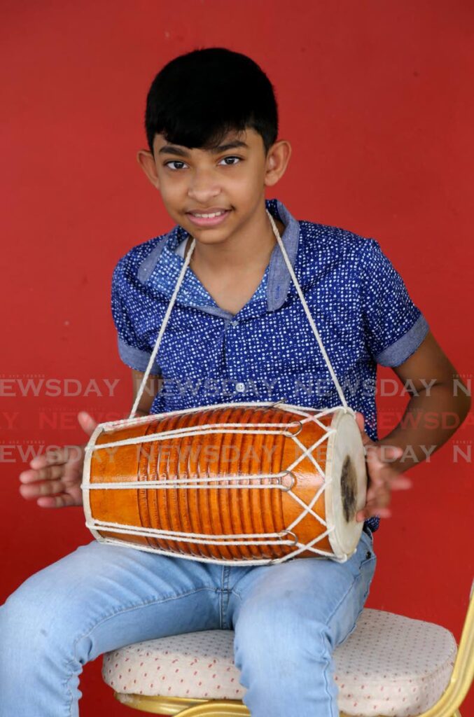 Avindha Singh plays the dholak at his home in Sangre Grande. He is the two-time primary schools Intellectual Chutney Soca Monarch - SUREASH CHOLAI