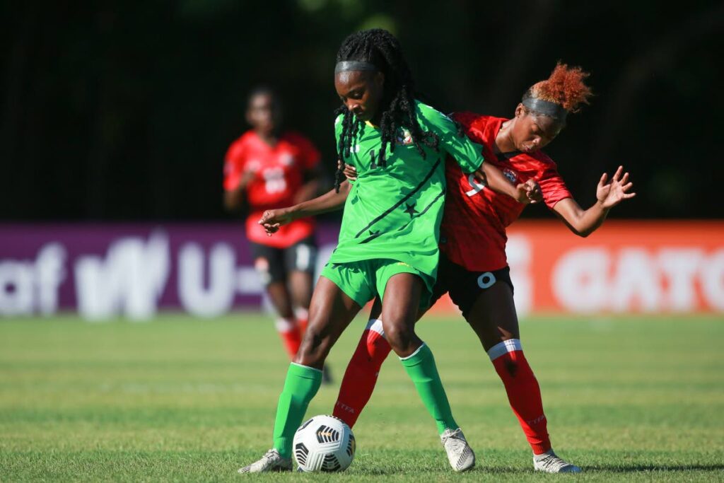St Kitts and Nevis' Iyalna Bailey-Williams (L) controls the ball against TT's Tori Paul, during the Concacaf Under 20 Women´s Championship Group G match, on Sunday, at Estadio Panamericano, San Cristobal, Dominican Republic. Photo courtesy CONCACAF