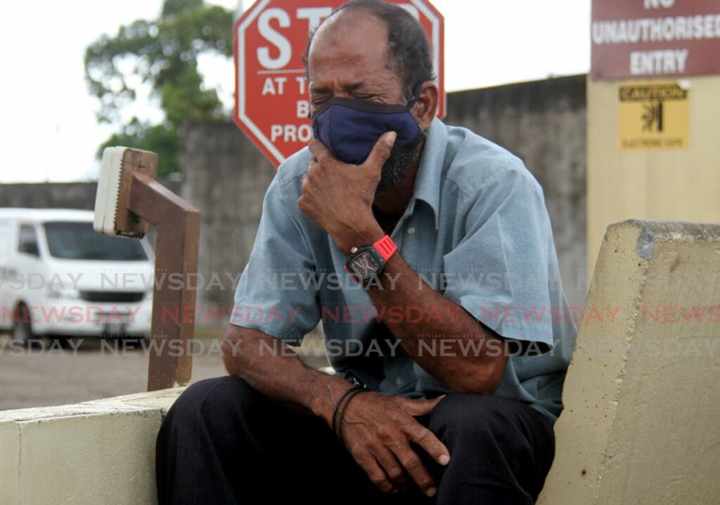 TEARS: Joseph Henry weeps outside the Forensic Science Centre in St James on Tuesday after identifying the body of his son Yusuf, one of the three divers whose bodies were retrieved on Monday. PHOTO BY AYANNA KINSALE - 