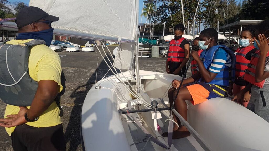 Sailing instructor Earl Tobias shares some pointers before the young sailors head out. - Courtesy TTSA