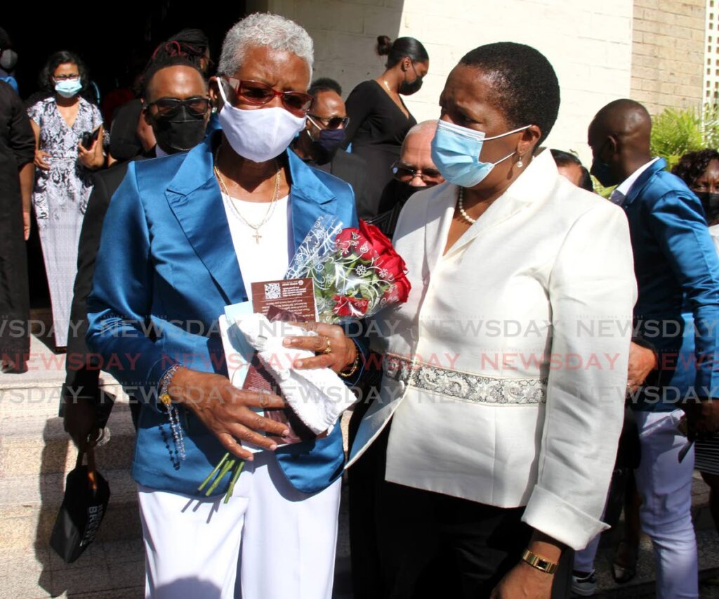 Arima MP Pennelope Beckles (R) consoles Chrispina Edmund, the mother of the late TT 400m runner and three-time Olympian Deon Lendore, at his funeral, on Thursday, at the Santa Rosa RC Church, Arima.  - AYANNA KINSALE