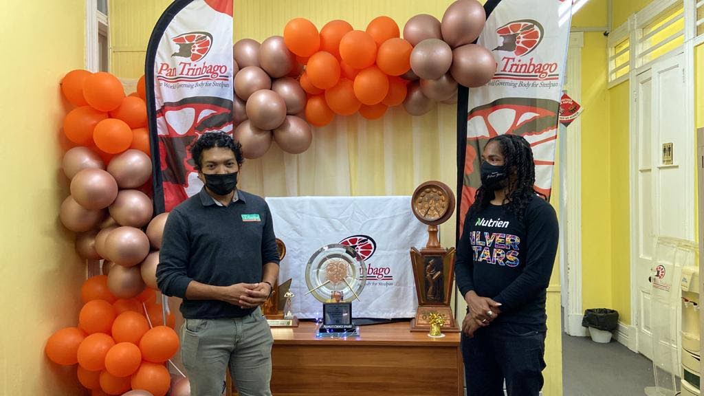 Unipet’s Rupert Jones presents Marcus Ash of Nutrien Silver Stars with the People’s Choice Trophy which the band earned for its performance on February 26 at Pan Trinbago's Musical Showdown in De Big Yard, Queen's Park Savannah, Port of Spain.  - 