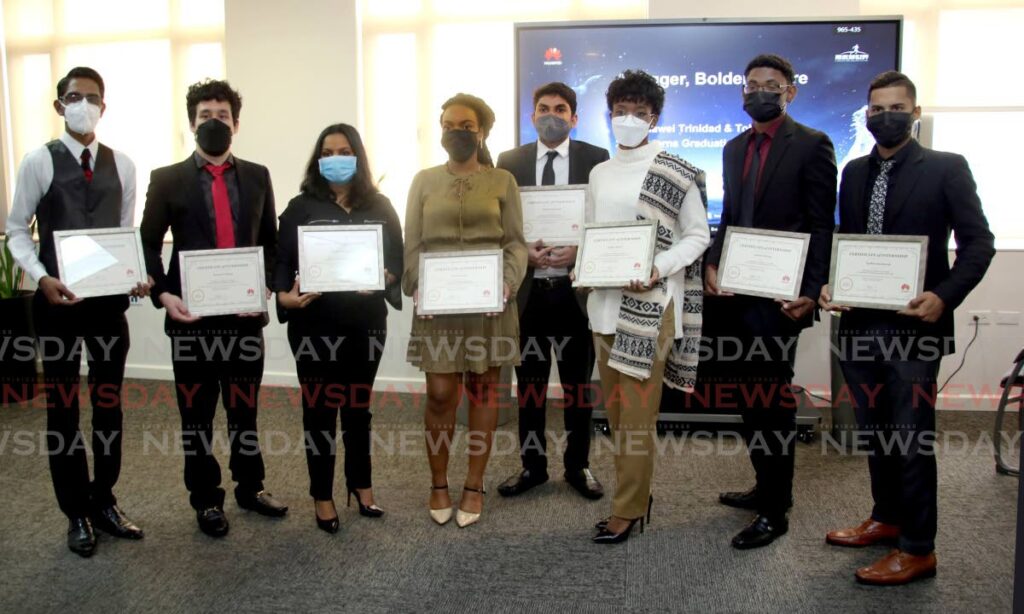 The graduates of the Huawei internship program pose with their certificates at Huawei TT's office at Park Place, Queen's Park Savannah, Port of Spain on March 4. - Photo Sureash Cholai