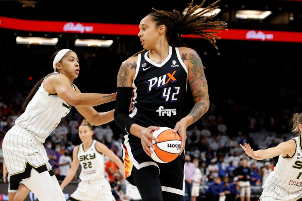 In this October 10, 2021 file photo, Phoenix Mercury center Brittney Griner (42) looks to pass as Chicago Sky center Candace Parker defends during the first half of game 1 of the WNBA Finals, in Phoenix.  On average a female professional basketballer receiving a salary from the WNBA is paid 98.5 per cent less than that of her male counterpart playing in the NBA. (AP Photo) - 