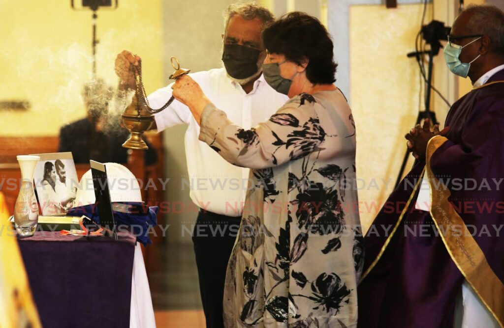 Kazim Ali and his wife Katherine offer incense during a memorial for their son Kazim Ali Jnr on Tuesday at the Our Lady of Perpetual Help RC Church in San Fernando. Ali Jr was among four divers who died in the Paria tragedy on February 25. PHOTO BY LINCOLN HOLDER - 