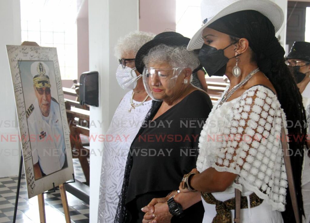 Penelope Afong, wife of masman Richard Afong is consoled by her niece Jeanille Bonterre at his funeral at the St. Theresas's RC Church, De Verteuil Street, Woodbrook. Afong, founder of Barbarossa, died on Carnival Tuesday. - Photo by Ayanna Kinsale