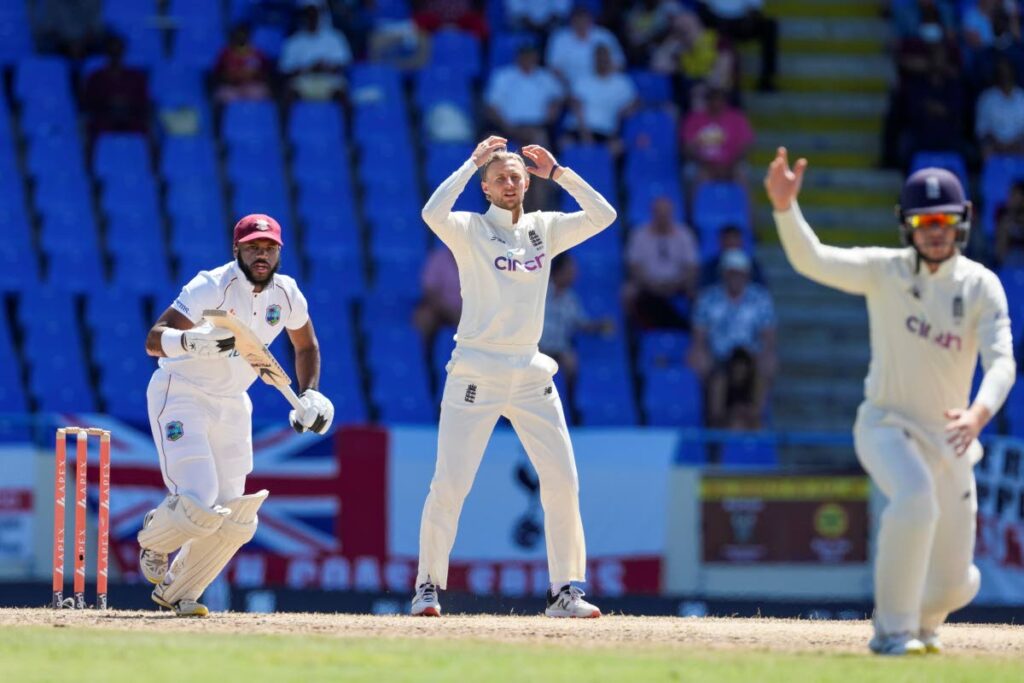England's captain Joe Root (C) gesture after a delivery to West Indies' captain Kraigg Brathwaite during day five of their first Test match at the Sir Vivian Richards Cricket Ground in North Sound, Antigua and Barbuda, on Saturday. (AP Photo) - 