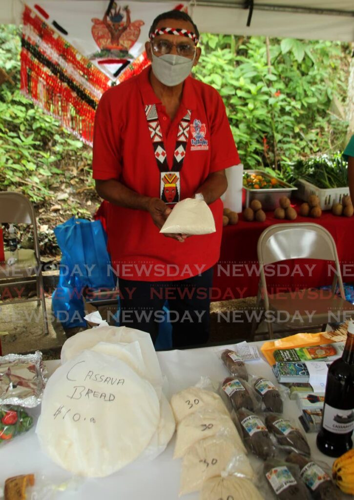 Santa Rosa First Peoples Chief Ricardo Bharath Hernandez offers cassava flour as an alternative to wheat flour during the observance of Commonwealth Day at the Green Market, Santa Cruz on Saturday.  - PHOTO BY ROGER JACOB