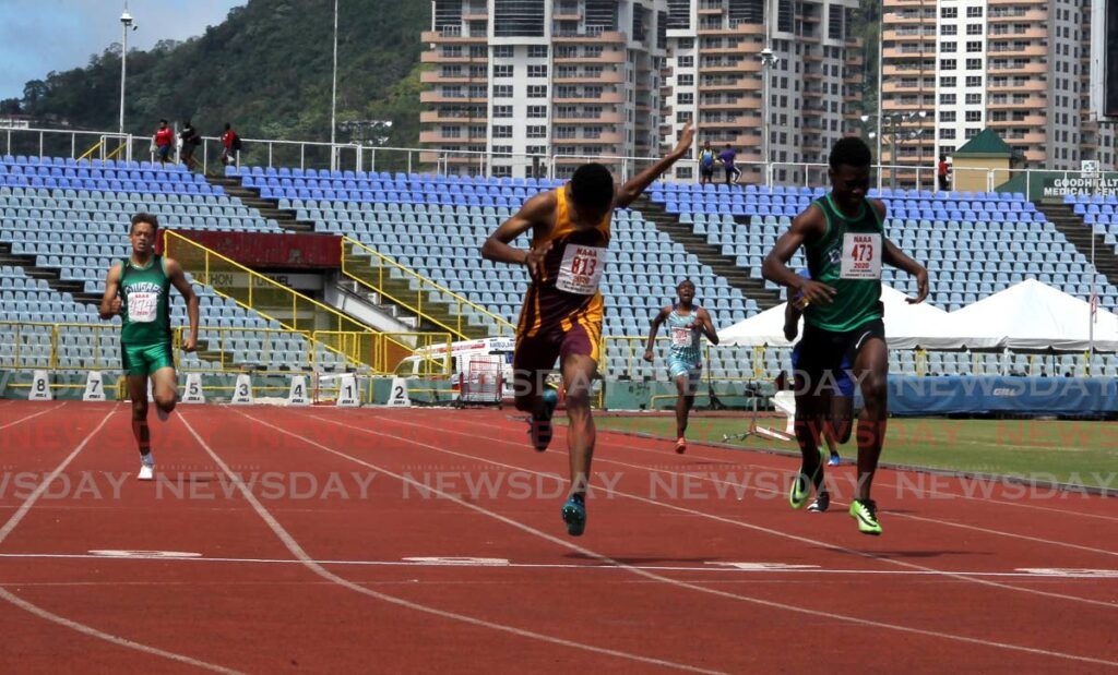 Kyle Williams (centre) gets the better of Kaiyin Morris to win the boys Under-17 400-metre race, on the first day of the Carifta Track and Field trials, at the Hasely Crawford Stadium, Mucurapo on Saturday. - ROGER JACOB