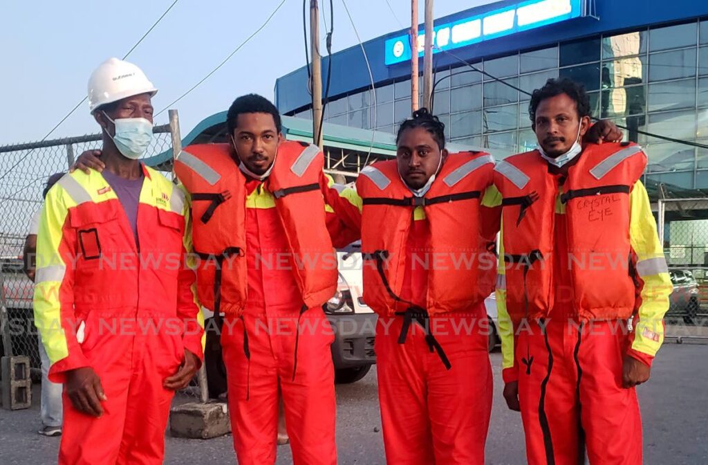 RESCUED: Fishermen (from left) James Kirwan, Jerome Nicome, Kyle Dyer and Azim Baksh at the Port of Port of Spain on Sunday evening after they arrived from Tobago aboard the TT Spirit. Less than 24 hours before, the men were drifting in the Caribbean Sea with just their life jackets on after their boat sank.  - ROGER JACOB