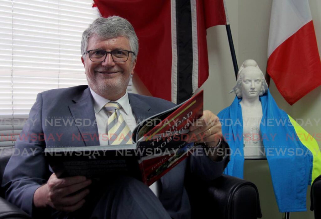 French Ambssador Didier Chabert reads up on Trinidad and Tobago at the French Embassy, Mary Street, St Clair. - PHOTO BY AYANNA KINSALE