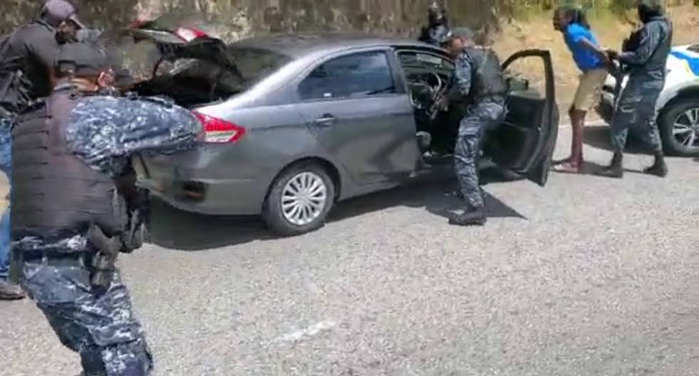 A screengrab of video showing dramatic search of car and arrest of prison escapee Anthony Seepersad along Morne Coco Road in Diego Martin on March 23.  - 