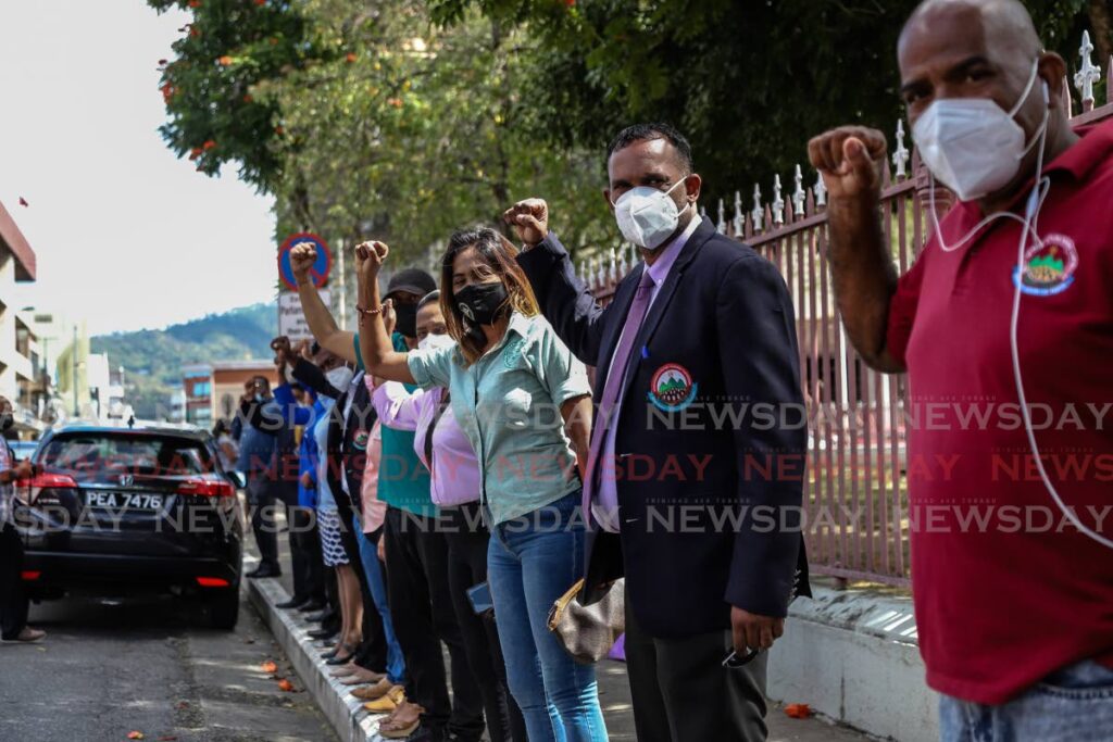 Council members of the Penal/Debe, Tunapuna/Piarco, and Couva/Tabaquite regional corporations stand opposite the Red House on Wednesday. Photo by Jeff Mayers