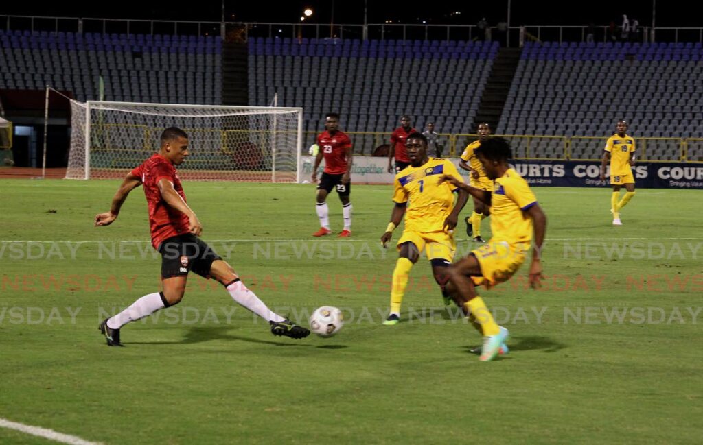 Trinidad and Tobago winger Ryan Telfer (left) tries to dribble past two defenders during Friday's match between TT and Barbados at the Hasely Crawford Stadium, Mucurapo. - ROGER JACOB